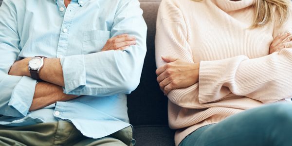 Divorce, fail and couple fight due to marriage problem, angry at home about family law and with conflict in a lounge. Anger, sad and people or partner frustrated due to infertility on a sofa