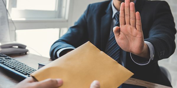 Businessman rejecting money in the envelope – anti bribery and c