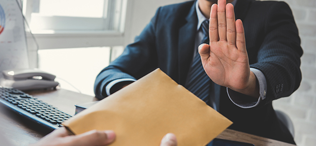 Businessman rejecting money in the envelope – anti bribery and c